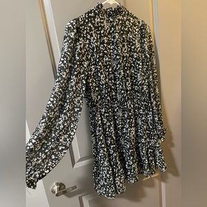 Black high neck dress with white and gold accents